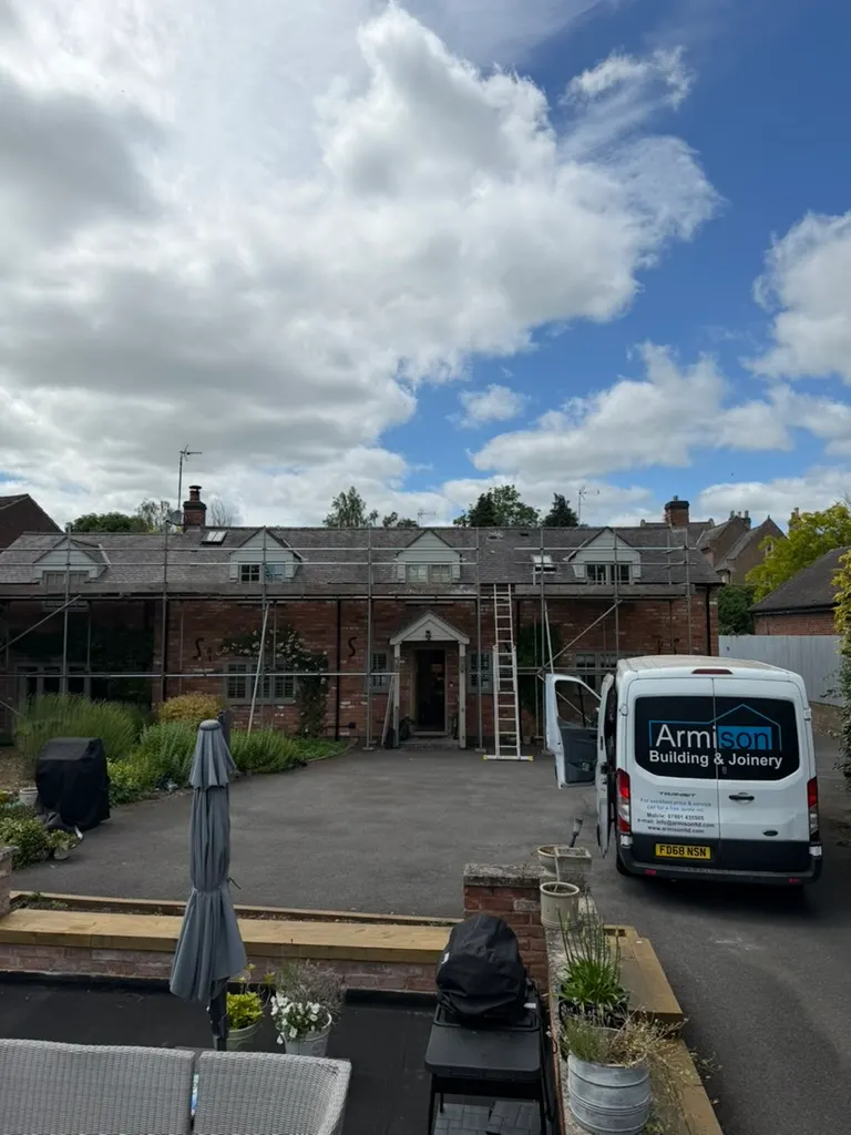 Armison Building and Joinery van on site outside a house with scaffolding
