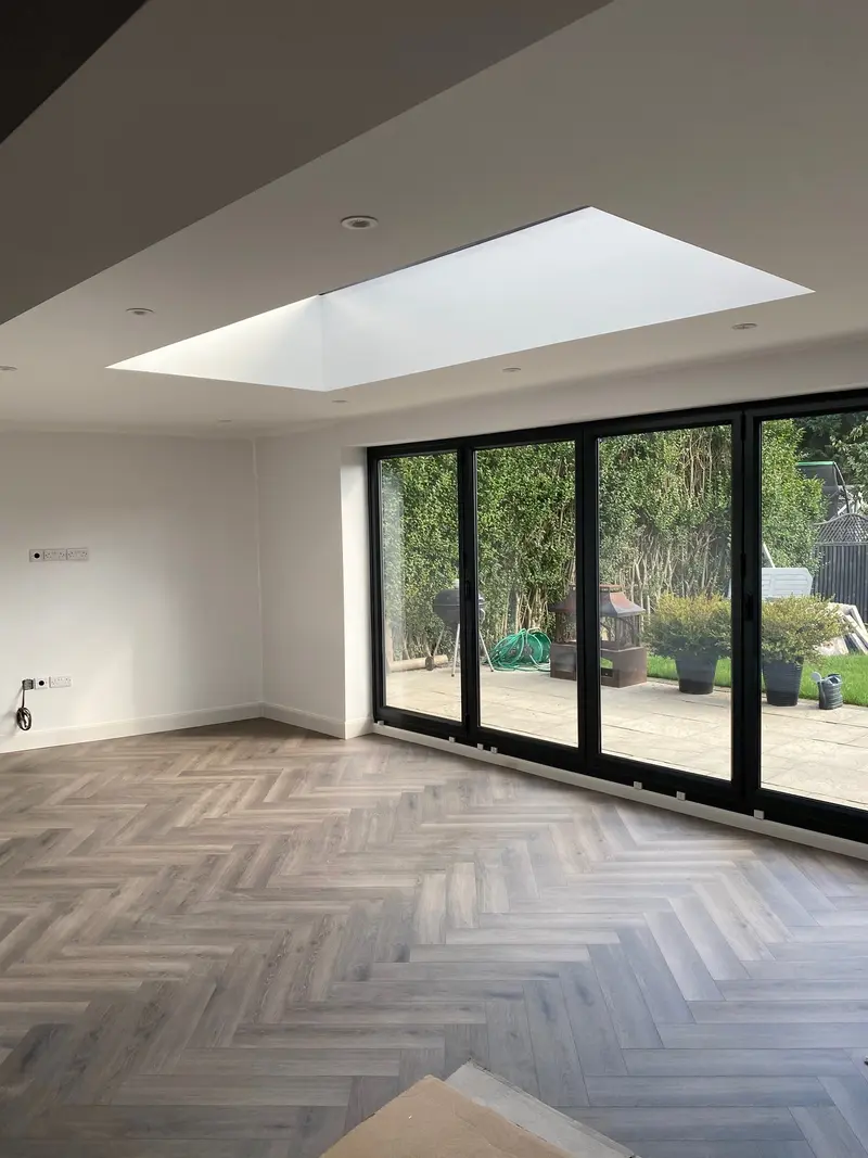 Open-plan Armison project with a rooflight, garden doors and herringbone flooring